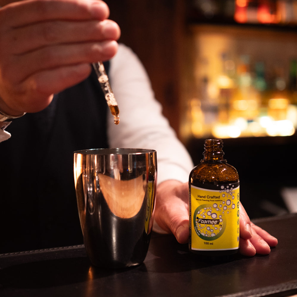 A bartender preparing a cocktail with Foamee.