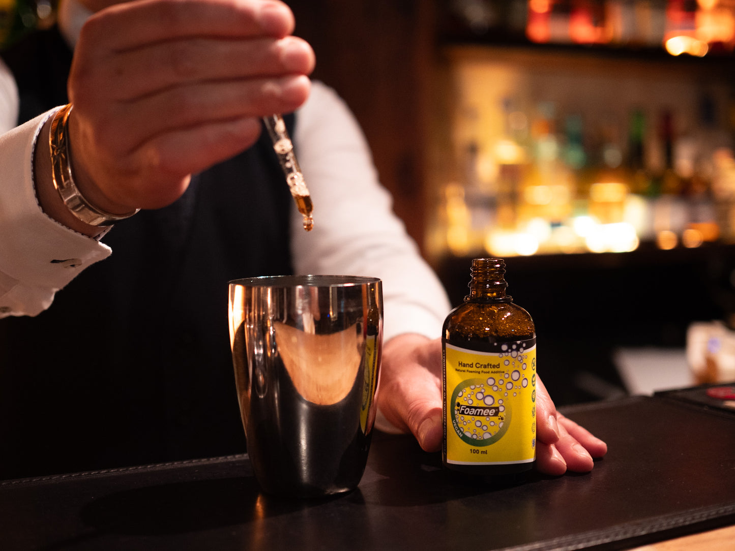 A bartender preparing a cocktail with Foamee.